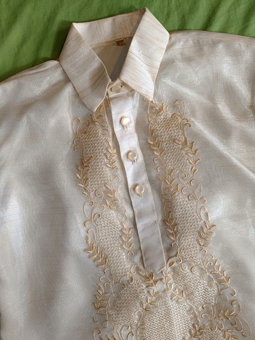 Kids Barong Tagalog - Size 12 (Category: Formal Shirts) located in Manila. Submitted by mecaart (Listing ID 1461409760, Image 2). Description: - Cream-colored Barong Tagalog shirt for boys - Size 12 - Pina Jusi - Intricate embroidery on the front - Long sleeves with button cuffs - Ideal for formal events and celebrations RFS: once lang nagamit during BUWAN NG WIKA celebration in school. Natambak lang. Maganda in person, makapal.