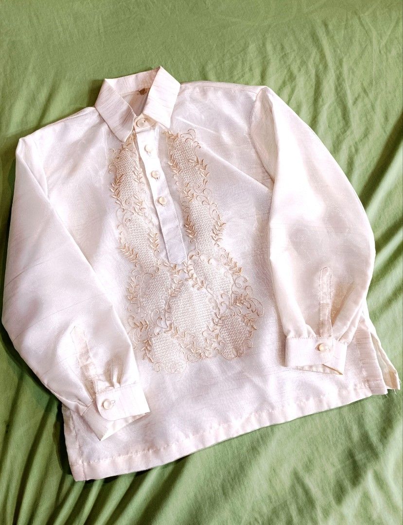 Kids Barong Tagalog - Size 12 (Category: Formal Shirts) located in Manila. Submitted by mecaart (Listing ID 1461409760, Image 1). Description: - Cream-colored Barong Tagalog shirt for boys - Size 12 - Pina Jusi - Intricate embroidery on the front - Long sleeves with button cuffs - Ideal for formal events and celebrations RFS: once lang nagamit during BUWAN NG WIKA celebration in school. Natambak lang. Maganda in person, makapal.