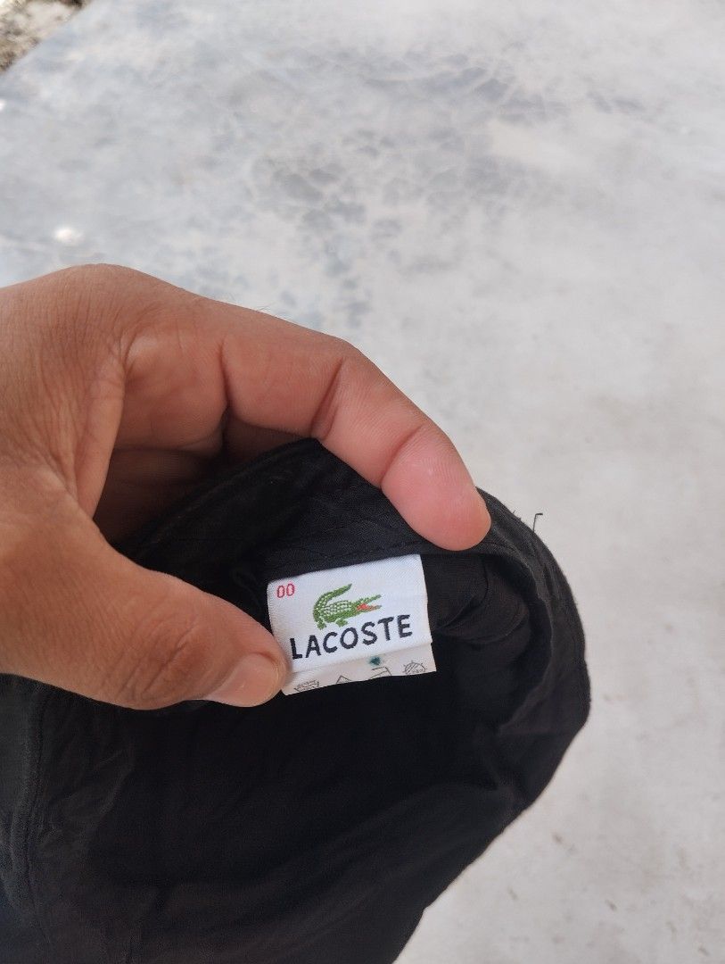 Lacoste Black Flat Cap Hat (Category: Caps & Hats) located in Mati. Submitted by old_era.ph (Listing ID 1461460409, Image 2). Description: - Classic black flat cap by Lacoste - Features iconic embroidered crocodile logo on the side - Made from comfortable material - Perfect for everyday wear - Adds a stylish and versatile touch to any outfit.