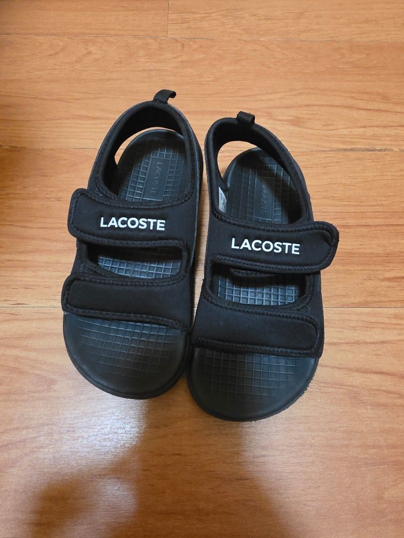 Lacoste Black Velcro Strap Sandals (Category: Babies & Kids Fashion) located in Manila. Submitted by philgabjhn (Listing ID 1461455262, Image 1). Description: - Brand: Lacoste - Color: Black - Style: Sandals - Features: Velcro straps for adjustable fit, grippy sole texture - Ideal for: Casual wear - Size: 1 UK / 33 EUR / 2 US.
