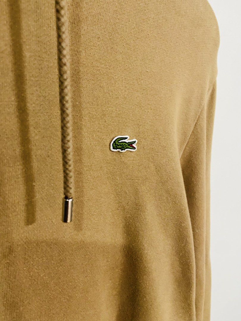 Lacoste Hoodie Tan Brown (Category: Hoodies) located in Manila. Submitted by thriftnijuan08 (Listing ID 1461344152, Image 2). Description: - Tan brown Lacoste hoodie - Size: US L / FR 5 - Classic crocodile logo on chest - Drawstring hood with metal aglets (Lacoste branded) - Front kangaroo pocket - Ideal for casual wear -Dimes 24/27.