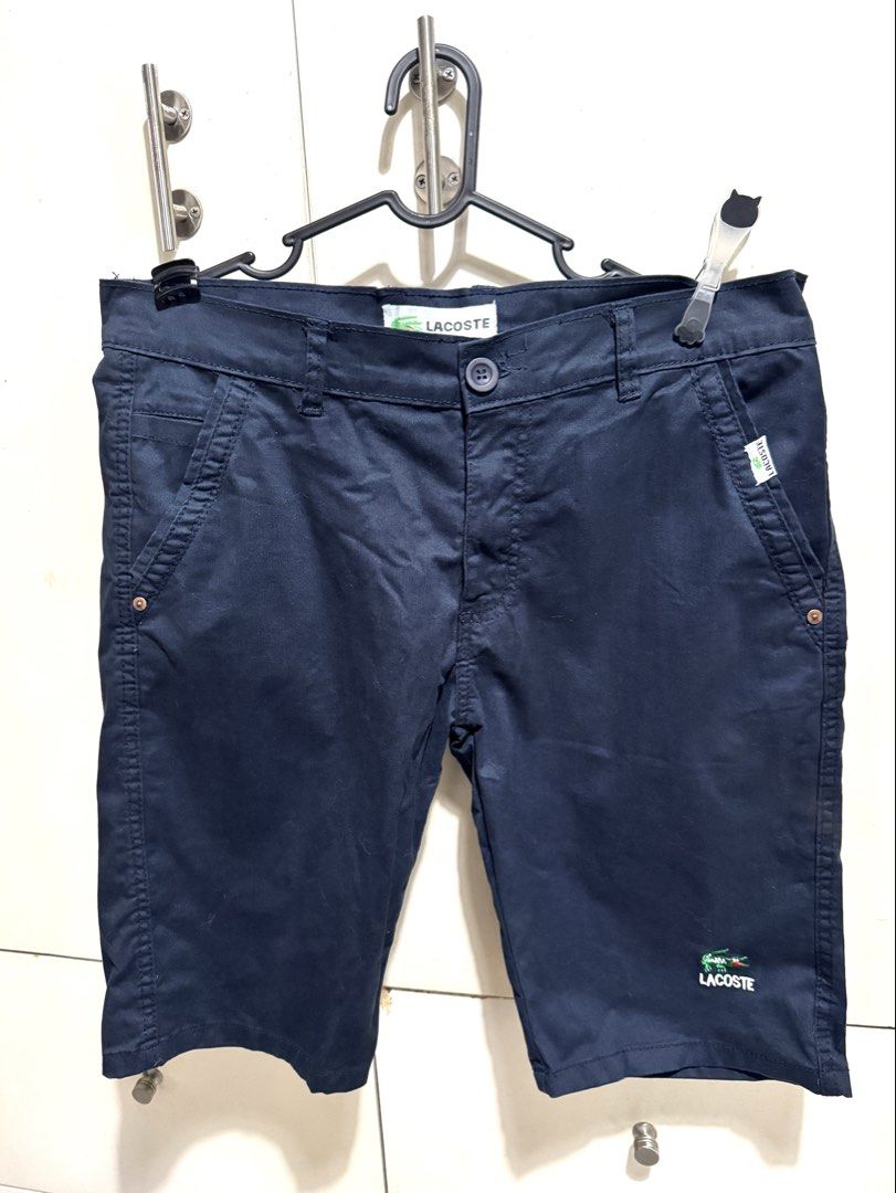 Lacoste Navy Blue Chino Shorts (Category: Shorts) located in Mandaluyong City. Submitted by spaceshipshop (Listing ID 1461463025, Image 1). Description: - Brand: Lacoste - Color: Navy Blue - Style: Chino Shorts - Fit: Classic - Closure: Button and zip - Pockets: Two front, two back - Detail: Small embroidered crocodile logo on front left leg - Occasion: Casual wear.