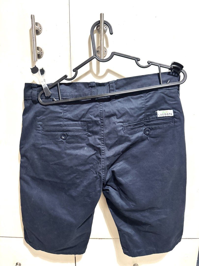 Lacoste Navy Blue Chino Shorts (Category: Shorts) located in Mandaluyong City. Submitted by spaceshipshop (Listing ID 1461463025, Image 2). Description: - Brand: Lacoste - Color: Navy Blue - Style: Chino Shorts - Fit: Classic - Closure: Button and zip - Pockets: Two front, two back - Detail: Small embroidered crocodile logo on front left leg - Occasion: Casual wear.