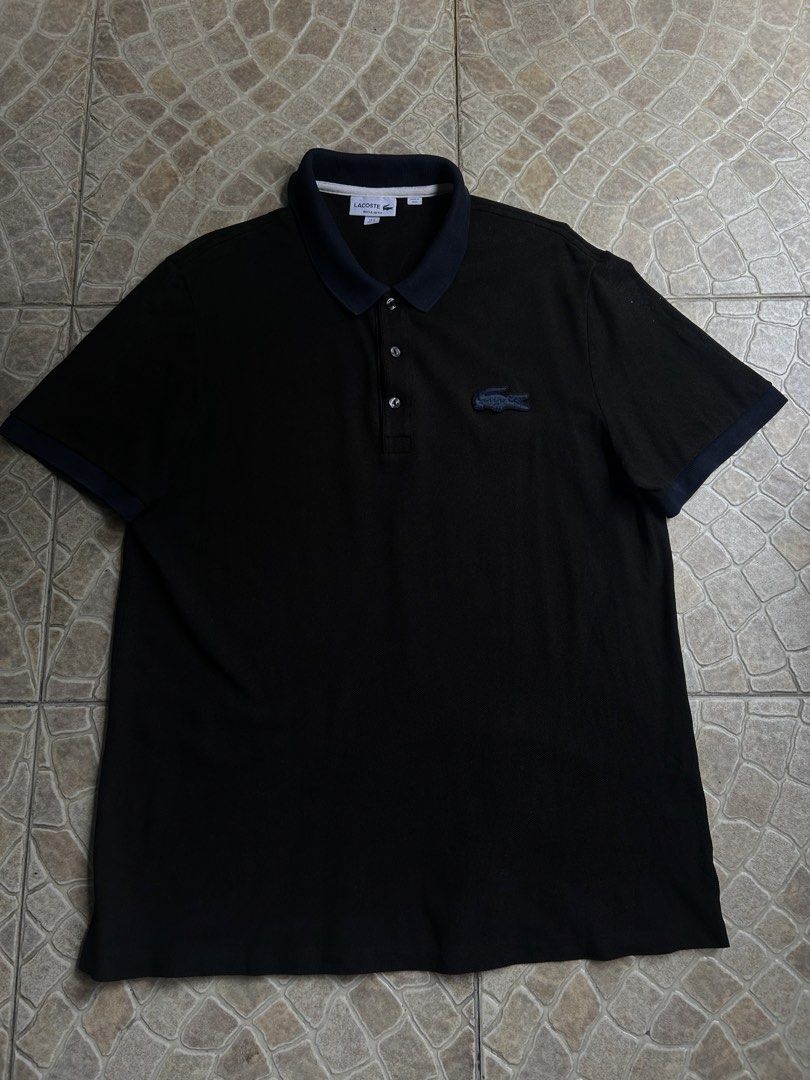 Lacoste Regular Fit Polo Shirt Black (Category: Tshirts & Polo Shirts ) located in Pasay City. Submitted by deguzmanjay (Listing ID 1461517246, Image 1). Description: - Classic black Lacoste polo shirt - Regular fit - Iconic crocodile logo on chest - Contrasting navy collar and sleeve cuffs - Button-up neckline - Made in Peru - Ideal for casual or smart-casual outfits.