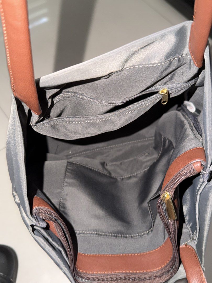 Le largo tote bag (Category: Tote Bags) located in Manila. Submitted by hatdognablue (Listing ID 1461360879, Image 3). Description: - Grey nylon tote bag - Brown faux leather handles - Zipper closure - Interior zippered pocket - Interior slip pocket - Ideal for everyday use - Spacious interior - Easy to carry.