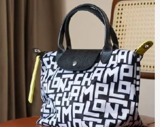 Le Pliage Cuir XS Top Handle Bag (Category: Cross-body Bags) located in Manila. Submitted by katkween23 (Listing ID 1461446478, Image 1). Description: - Super cute Longchamp bag - All-over logo print in black and white - Features top handles - Detachable shoulder strap included - Comes with original tag and dust bag - Small size, ideal for essentials - Versatile for everyday use or nights out.