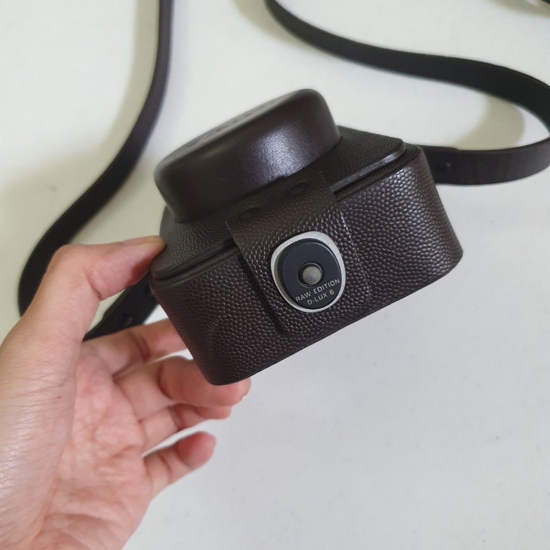 Leica D-LUX 6 RAW EDITION Leather Camera Case with Strap (Category: Camera Bags & Carriers) located in Paranaque City. Submitted by cobien (Listing ID 1461450465, Image 3). Description: - Genuine brown leather camera case - Specifically for Leica D-LUX 6 RAW EDITION - Includes a matching leather strap - Soft interior lining for camera protection - Stylish and practical for everyday carrying.