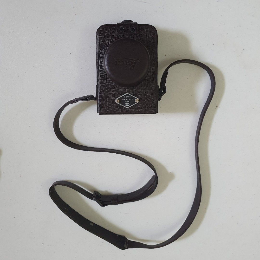 Leica D-LUX 6 RAW EDITION Leather Camera Case with Strap (Category: Camera Bags & Carriers) located in Paranaque City. Submitted by cobien (Listing ID 1461450465, Image 2). Description: - Genuine brown leather camera case - Specifically for Leica D-LUX 6 RAW EDITION - Includes a matching leather strap - Soft interior lining for camera protection - Stylish and practical for everyday carrying.