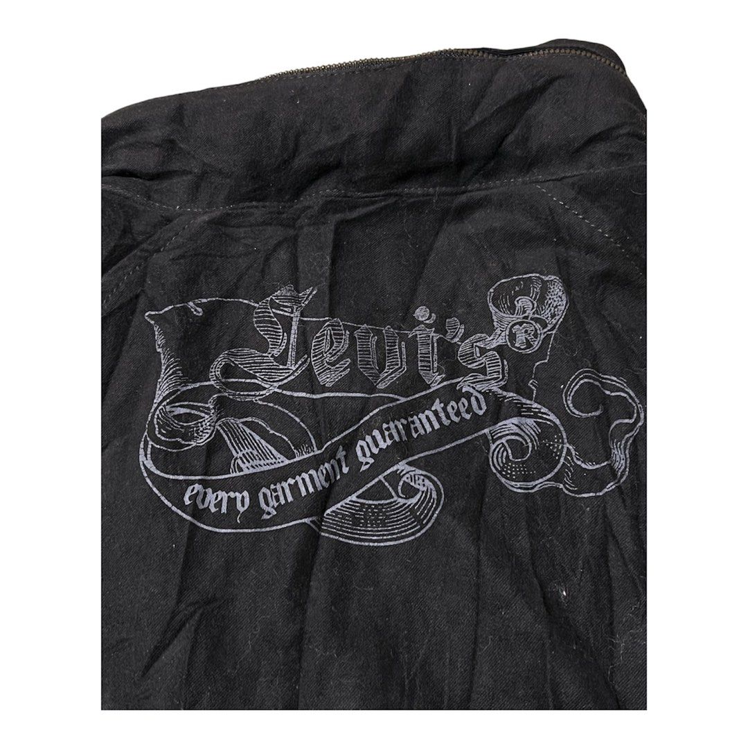 Levi's Black Denim Hooded Jacket (Category: Coats, Jackets and Outerwear) located in Davao. Submitted by thriftitemsss (Listing ID 1461459805, Image 3). Description: Y2k 18x26 - Classic black Levi's jacket - Attached hood for extra warmth - Multiple front pockets for storage - Secure zipper and button closure - Eye-catching graphic print on the back - Made in Macau - 100% Cotton material - Machine wash warm for easy care.