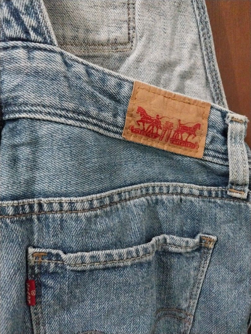 Levi's Denim Short Overalls (Category: Jumpsuits) located in Aroroy. Submitted by imeea (Listing ID 1461432390, Image 3). Description: - Classic Levi's denim short overalls - Light wash with distressed details - Adjustable straps - Button closures on the sides - Two front and two back pockets - Rolled hem shorts - Ideal for a casual, laid-back look.