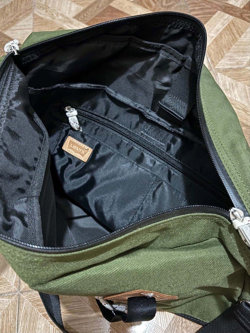 Levi's Green and Black Duffle Bag (Category: Sling Bags) located in Tacloban City. Submitted by rdtbb (Listing ID 1461371648, Image 2). Description: - Stylish green and black duffel bag - Spacious main compartment with internal pockets - Convenient front zip pocket for quick access - Includes a detachable shoulder strap for comfortable carrying - Ideal for gym sessions or weekend getaways - Made with durable material for long-lasting use.