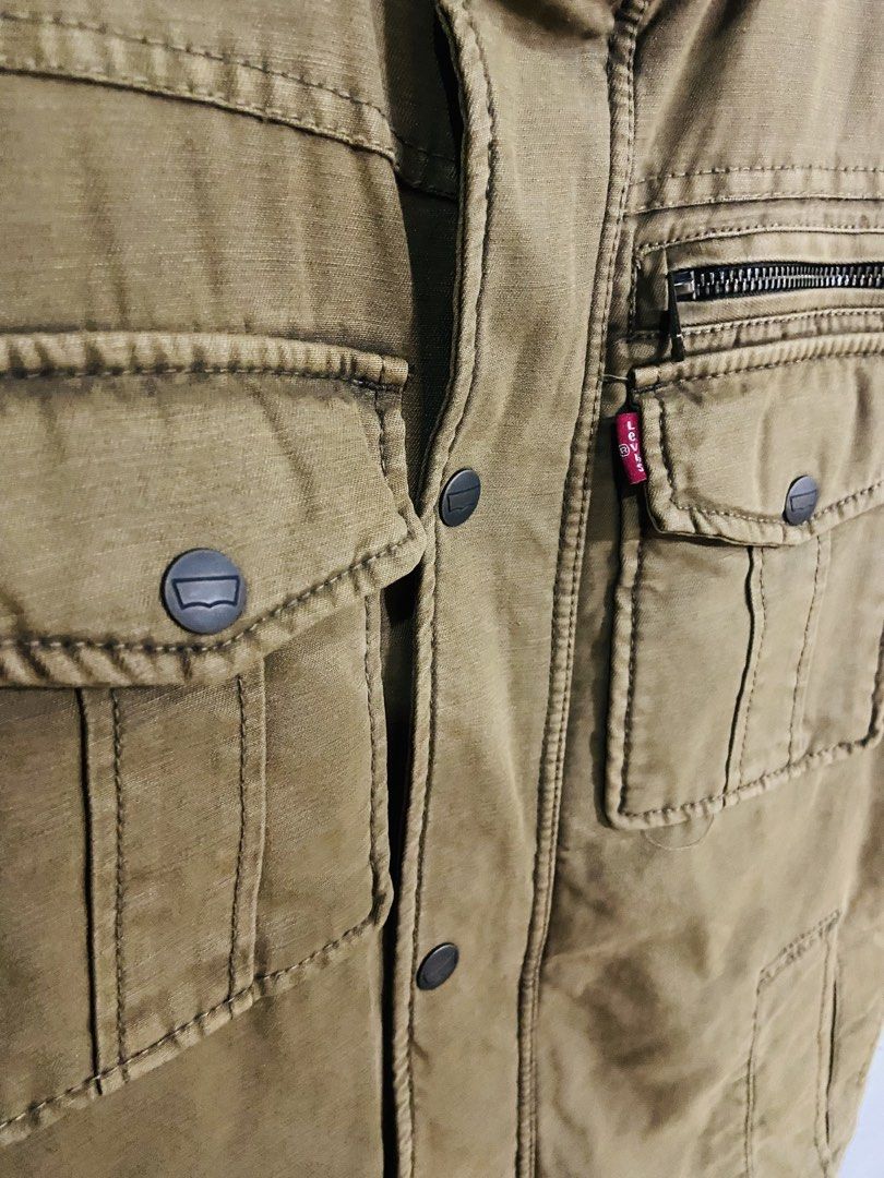 Levi's Sherpa Lined Trucker Jacket (Category: Coats, Jackets and Outerwear) located in Manila. Submitted by thriftnijuan08 (Listing ID 1461340017, Image 3). Description: - Classic Levi's brown canvas jacket - Warm sherpa fleece lining - Quilted interior for extra warmth - Multiple front pockets: 2 snap chest pockets, 2 zippered pockets - Button-down front closure - Ideal for cooler weather -Dimes 20/26.