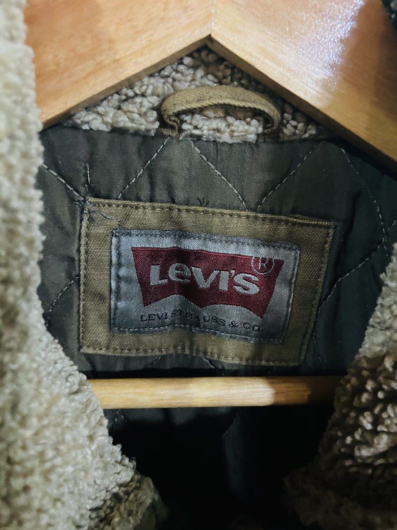 Levi's Sherpa Lined Trucker Jacket (Category: Coats, Jackets and Outerwear) located in Manila. Submitted by thriftnijuan08 (Listing ID 1461340017, Image 2). Description: - Classic Levi's brown canvas jacket - Warm sherpa fleece lining - Quilted interior for extra warmth - Multiple front pockets: 2 snap chest pockets, 2 zippered pockets - Button-down front closure - Ideal for cooler weather -Dimes 20/26.