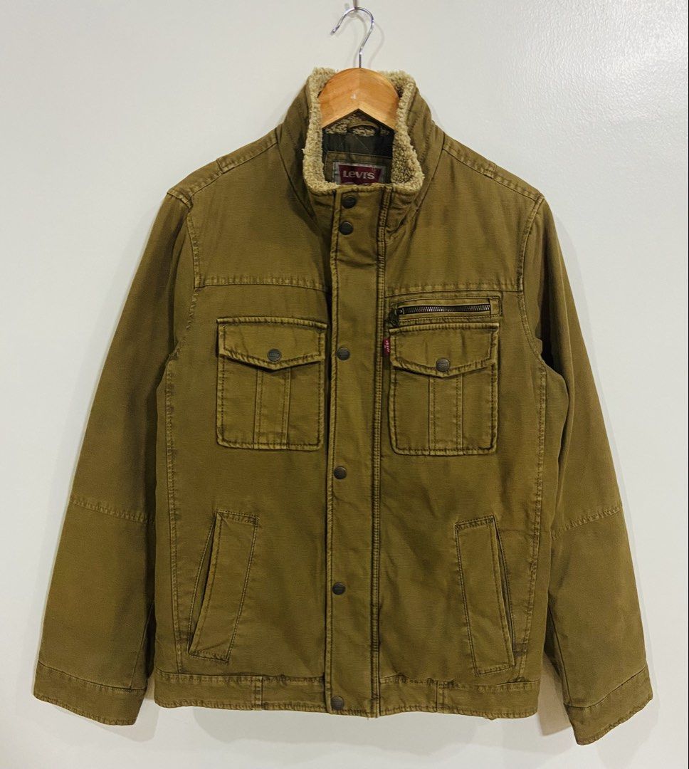 Levi's Sherpa Lined Trucker Jacket (Category: Coats, Jackets and Outerwear) located in Manila. Submitted by thriftnijuan08 (Listing ID 1461340017, Image 1). Description: - Classic Levi's brown canvas jacket - Warm sherpa fleece lining - Quilted interior for extra warmth - Multiple front pockets: 2 snap chest pockets, 2 zippered pockets - Button-down front closure - Ideal for cooler weather -Dimes 20/26.