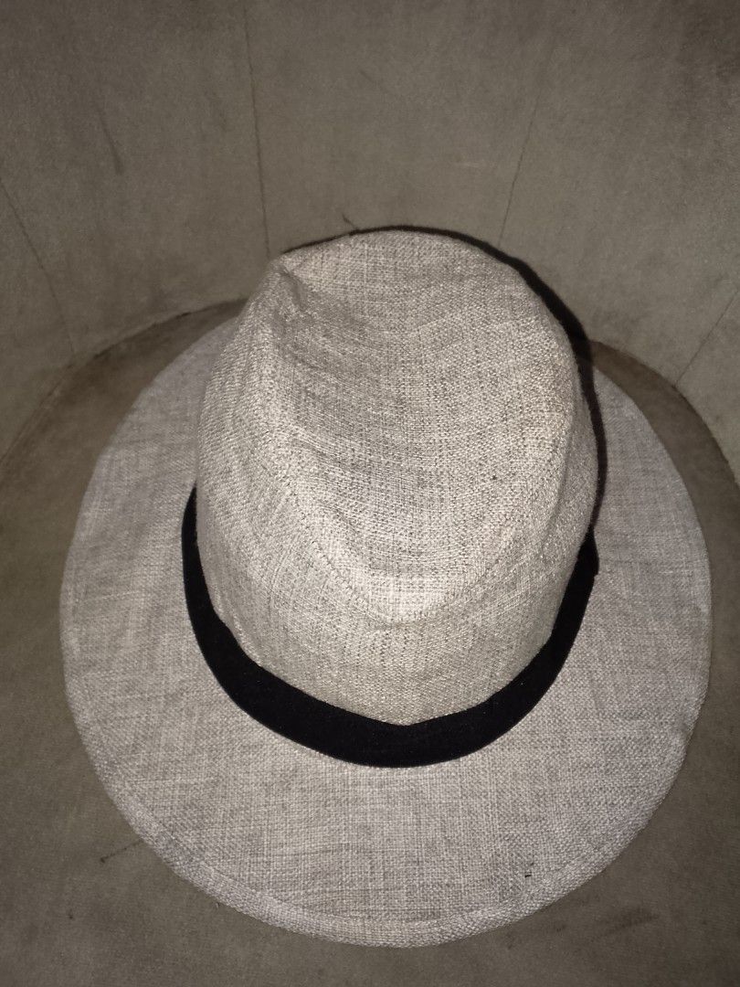 Light Gray Woven Cowboy Style Fedora Hat LtoXL (Category: Caps & Hats) located in Binangonan. Submitted by yuristalin888 (Listing ID 1461374889, Image 3). Description: Complete your warm-weather look with this breezy light gray fedora hat, featuring a lightweight textured weave and a classic pinched crown design. Contrasted with a wide black ribbon band, this stylish and versatile accessory offers effortless sun protection and timeless casual ele