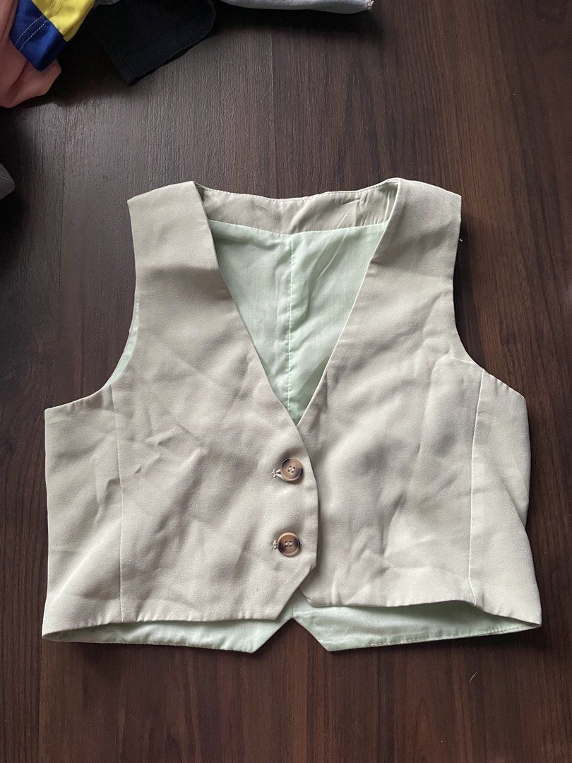 Light green Vest cropped button down (Category: Others Tops) located in Quezon City. Submitted by andreaaa_______ (Listing ID 1461429300, Image 1). Description: - second hand manage expectations - measurements in photos no more tag so idk size or brand few pulled threads - Features a classic two-button front closure. .