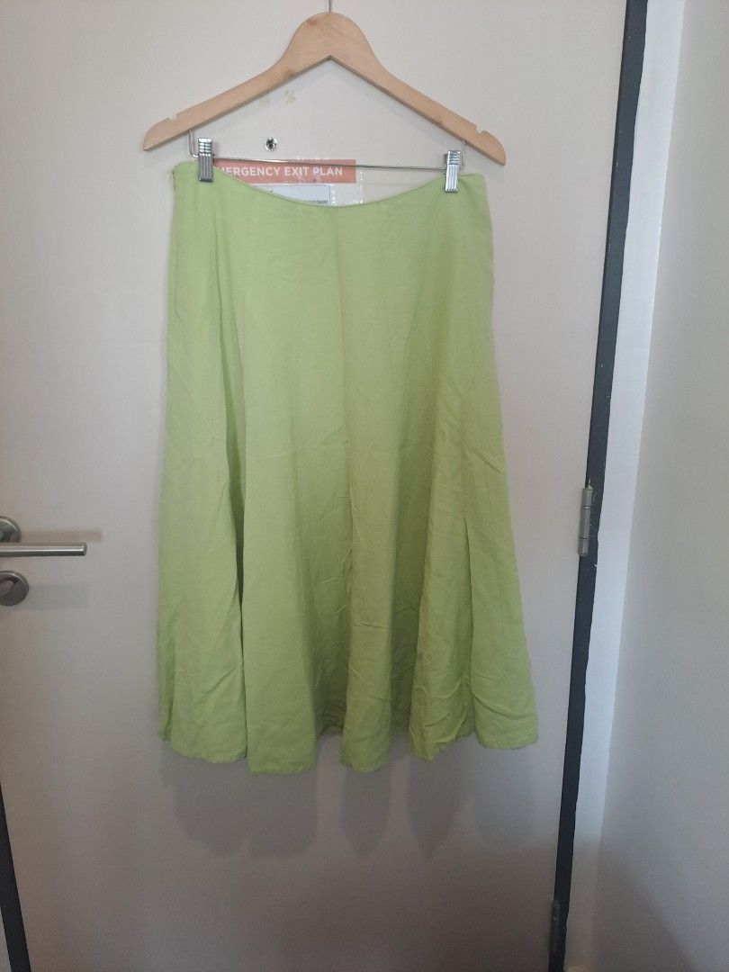 Linen blend Skirt apple green (Category: Other Bottoms) located in Manila. Submitted by joanbalde39643 (Listing ID 1461423810, Image 2). Description: The item pictured is a light green A-line midi skirt featuring a fluid, slightly paneled flare design..