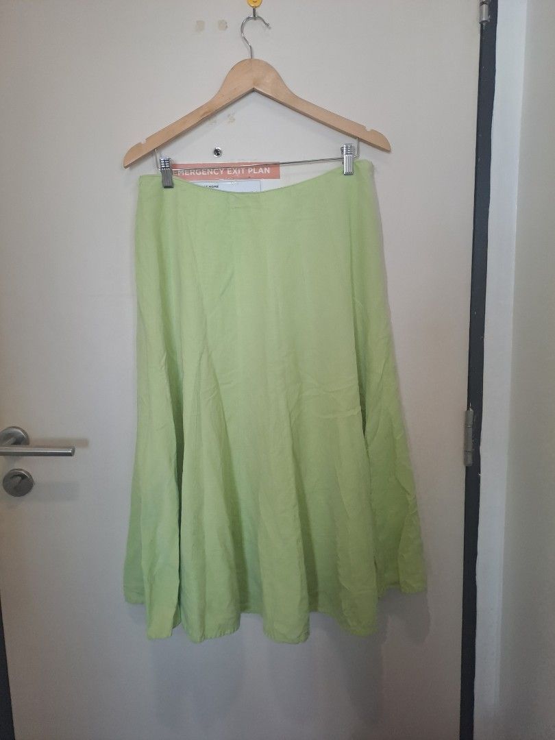 Linen blend Skirt apple green (Category: Other Bottoms) located in Manila. Submitted by joanbalde39643 (Listing ID 1461423810, Image 1). Description: The item pictured is a light green A-line midi skirt featuring a fluid, slightly paneled flare design..