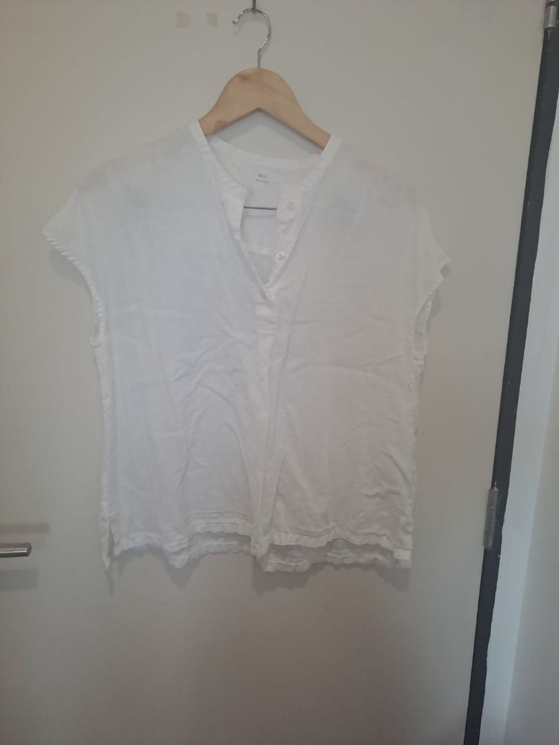 linen boxy tops (Category: Blouses) located in Mandaluyong City. Submitted by epicowl-c93c (Listing ID 1461426583, Image 1). Description: This lightweight white linen-blend popover blouse features a split mandarin collar with a classic button-up henley placket and comfortable cap sleeves. It offers a relaxed, boxy silhouette with curved hem slits, making it a perfect, breathable staple for warm weather..