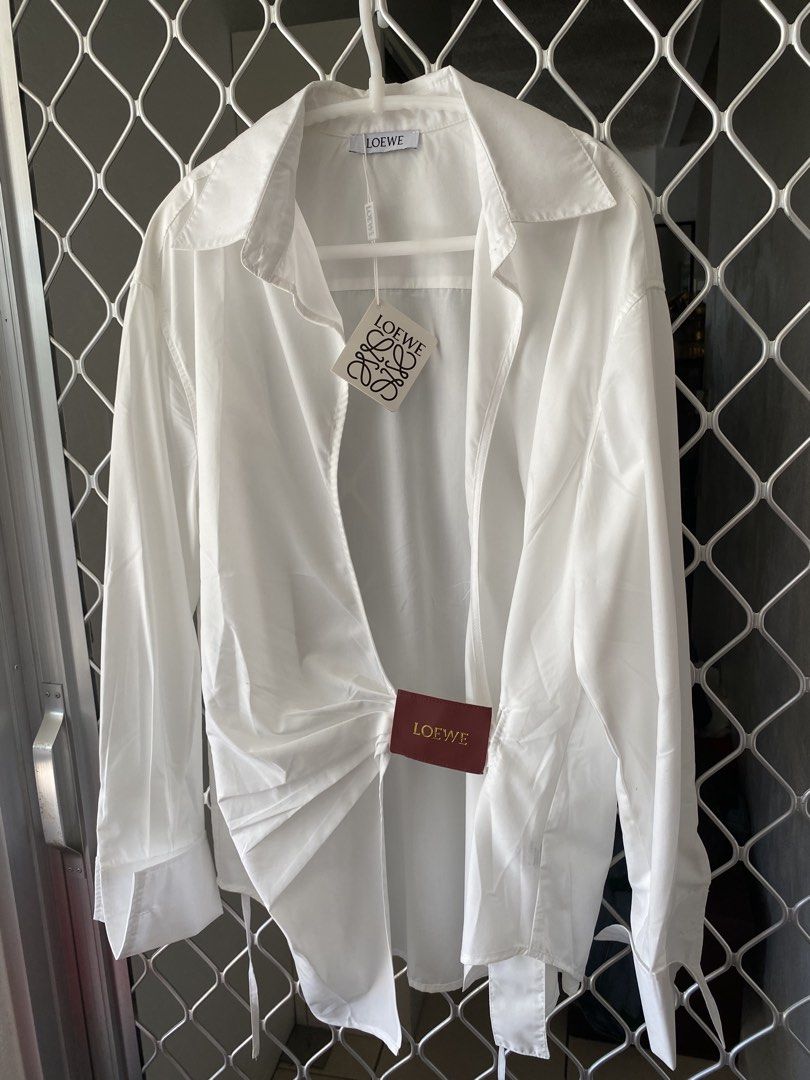 loewe wrap shirt brand new (Category: Luxury Apparel) located in Makati City. Submitted by celebrityauctions (Listing ID 1461448798, Image 3). Description: Title: Authentic LOEWE Wrap-Effect Leather-Trimmed Cotton-Poplin Shirt – White (Size L) - Brand New with TagsDescription:Elevate your luxury wardrobe with this stunning, authentic LOEWE Wrap-Effect Leather-Trimmed Cotton-Poplin Shirt. Combining immaculate Spanish craftsmanship with contemporar