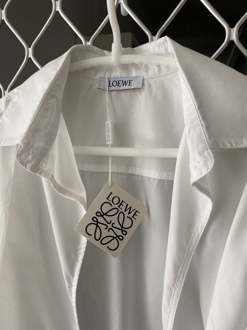 loewe wrap shirt brand new (Category: Luxury Apparel) located in Makati City. Submitted by celebrityauctions (Listing ID 1461448798, Image 2). Description: Title: Authentic LOEWE Wrap-Effect Leather-Trimmed Cotton-Poplin Shirt – White (Size L) - Brand New with TagsDescription:Elevate your luxury wardrobe with this stunning, authentic LOEWE Wrap-Effect Leather-Trimmed Cotton-Poplin Shirt. Combining immaculate Spanish craftsmanship with contemporar