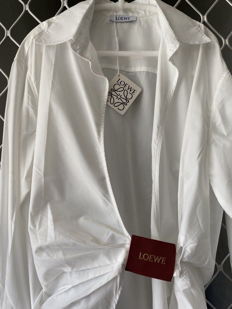 loewe wrap shirt brand new (Category: Luxury Apparel) located in Makati City. Submitted by celebrityauctions (Listing ID 1461448798, Image 1). Description: Title: Authentic LOEWE Wrap-Effect Leather-Trimmed Cotton-Poplin Shirt – White (Size L) - Brand New with TagsDescription:Elevate your luxury wardrobe with this stunning, authentic LOEWE Wrap-Effect Leather-Trimmed Cotton-Poplin Shirt. Combining immaculate Spanish craftsmanship with contemporar