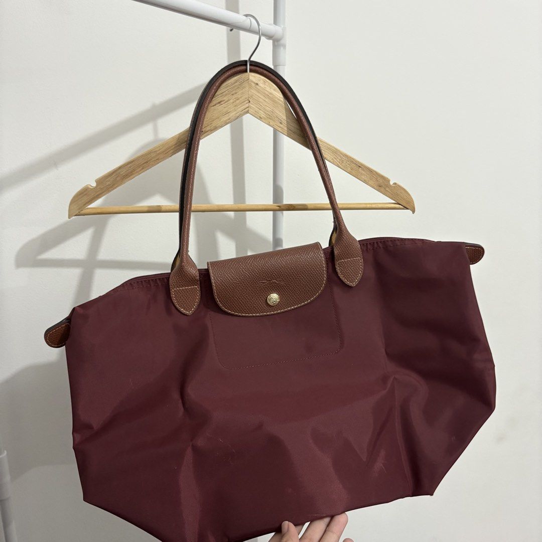 Longchamp - Le Pliage Tote Bag (Burgundy, Large) (Category: Luxury Bags & Wallets) located in Quezon City. Submitted by thisisshobe (Listing ID 1461478956, Image 2). Description: 🌊 NOTE: Kindly read the reminders posted in the product slideshow. Follow us on our Social Media Page: Sunny Clothing PH 🌞 ——— 💫 Product Information • Brand: Longchamp • Size: Large • Details: Vietnam-made only; Has visible small flaws.