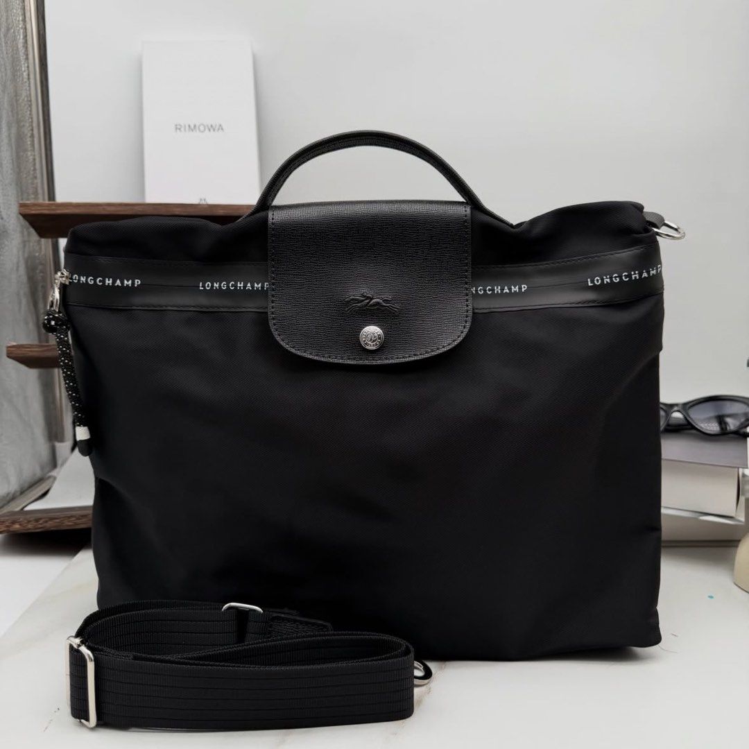 Longchamp Le Pliage Energy Briefcase - Black Canvas (Category: Briefcases) located in Manila. Submitted by lottielabouff (Listing ID 1461380727, Image 1). Description: Longchamp Le Pliage Energy Briefcase Color: Black Canvas Accommodates a 14-inch Laptop Dimensions : 37 cm (L - measured at the base of the bag) x 28 cm (H) x 8 cm (W) Material : 100% polyamide canvas made with 100% recycled fibers Metallic Hardware : Silver color Trimming : Cowhide