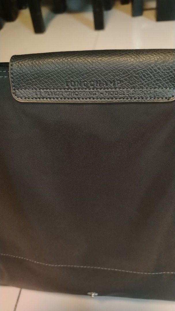 Longchamp Le Pliage Shopping Tote Bag (Category: Luxury Bags & Wallets) located in Manila. Submitted by wildwind_73f77a (Listing ID 1461483222, Image 3). Description: - Classic Longchamp tote bag - Color: Dark Grey - Material: Leather trim and handles - Closure: Zipper with snap button flap - Features: Spacious interior - Ideal for: Everyday use or travel.