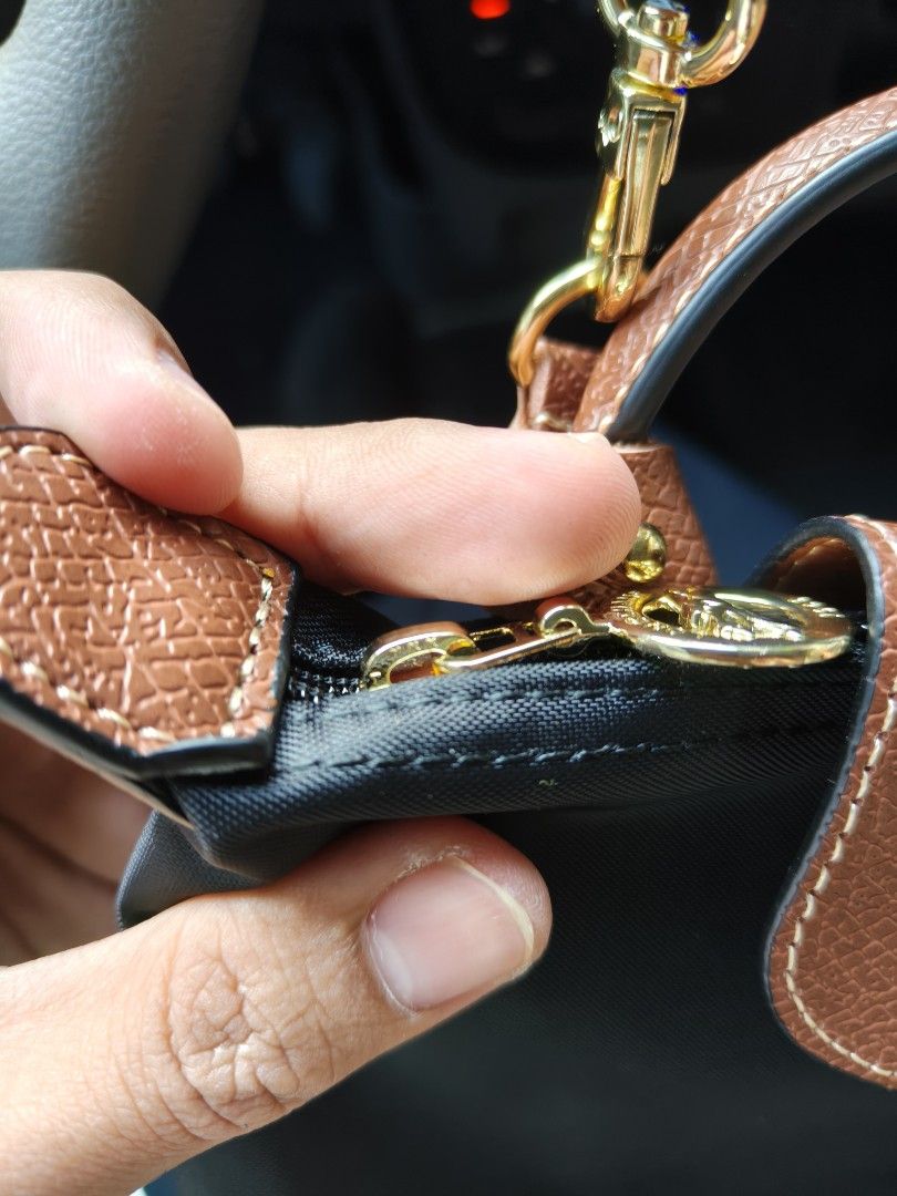 Longchamp Paris Le Pliage Cuir Small Top Handle Bag (Category: Luxury Bags & Wallets) located in Davao. Submitted by navil01 (Listing ID 1461394391, Image 2). Description: - Longchamp Paris handbag - YKK Zipper - Made in France - Color: Black nylon with brown leather trim - Hardware: Gold - Closure: Zipper - Size: Small (ideal for essentials) - Versatile: Can be worn as a top handle or crossbody (strap not included).