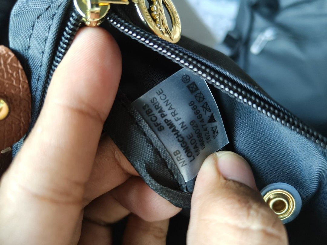 Longchamp Paris Le Pliage Cuir Small Top Handle Bag (Category: Luxury Bags & Wallets) located in Davao. Submitted by navil01 (Listing ID 1461394391, Image 3). Description: - Longchamp Paris handbag - YKK Zipper - Made in France - Color: Black nylon with brown leather trim - Hardware: Gold - Closure: Zipper - Size: Small (ideal for essentials) - Versatile: Can be worn as a top handle or crossbody (strap not included).