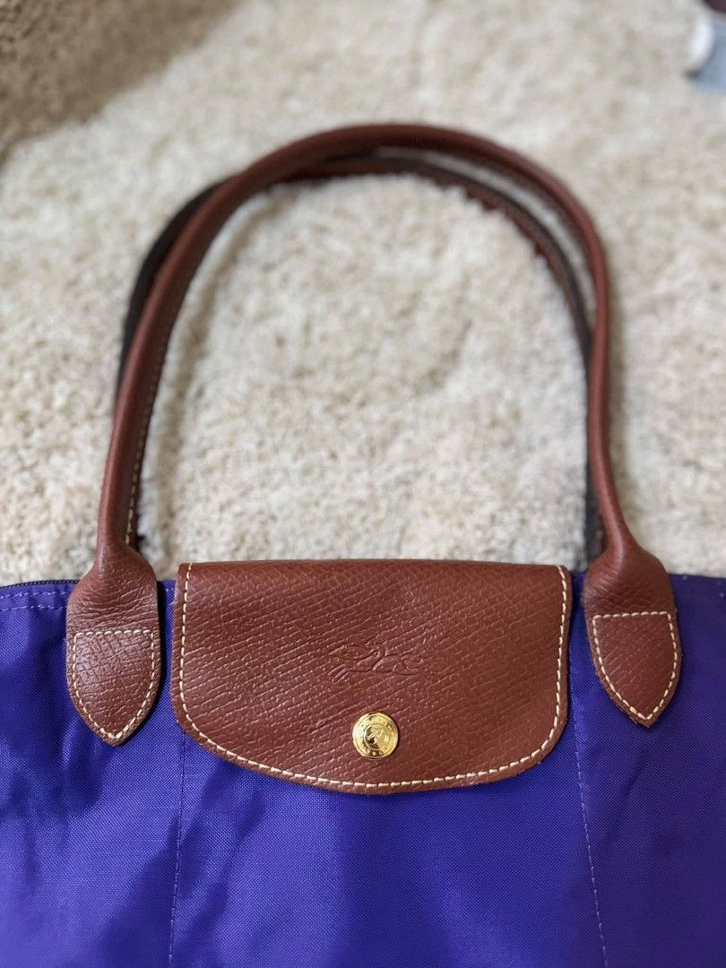 Longchamp Paris Le Pliage Tote Bag (Category: Luxury Bags & Wallets) located in Manila. Submitted by shy177 (Listing ID 1461384169, Image 1). Description: - Authentic Longchamp Paris Le Pliage tote bag - Made in Tunisia - Vibrant purple color with brown leather accents - Zipper closure - Ideal for everyday use or travel - Spacious interior.