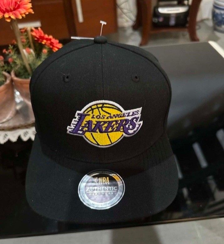 Los Angeles LAKERS AUTHENTIC HEADGEAR (Category: Activewear) located in Manila. Submitted by noblecrystal2026 (Listing ID 1461370840, Image 1). Description: BRANDNEW ORIGINAL WITH RECEIPT SIZE: ONE SIZE FITS MOST SHIPS NATIONWIDE DESCRIPTION; - black Los Angeles Lakers - Features the iconic Lakers logo embroidered on the front. - MLB logo embroidered on the back. - NBA Authentic Headwear. - Original tags still attached. - Perfect for any Lakers f