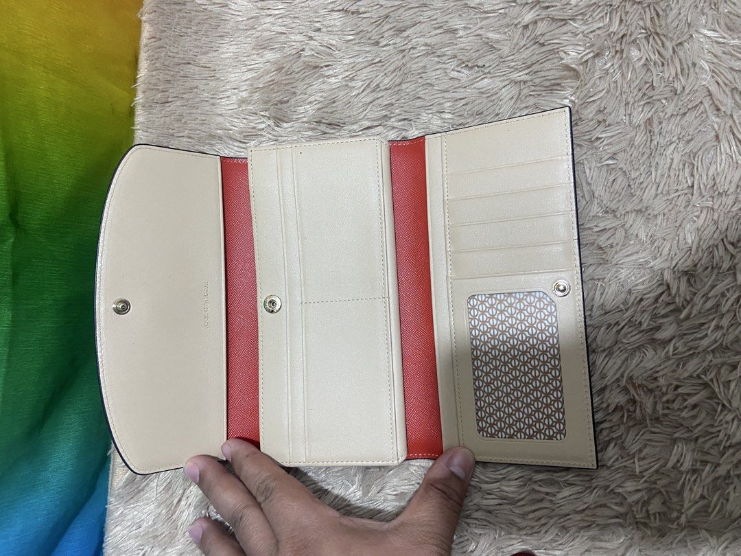 Louis Quatorze Red Leather Long Wallet (Category: Wallets & Card holders) located in Pasig City. Submitted by jie_russ (Listing ID 1461425432, Image 2). Description: - Authentic Louis Quatorze red leather long wallet - Elegant gold emblem on the front - Beige interior with stylish red accents - Ample card slots and compartments for organization - Secure and convenient snap closure.