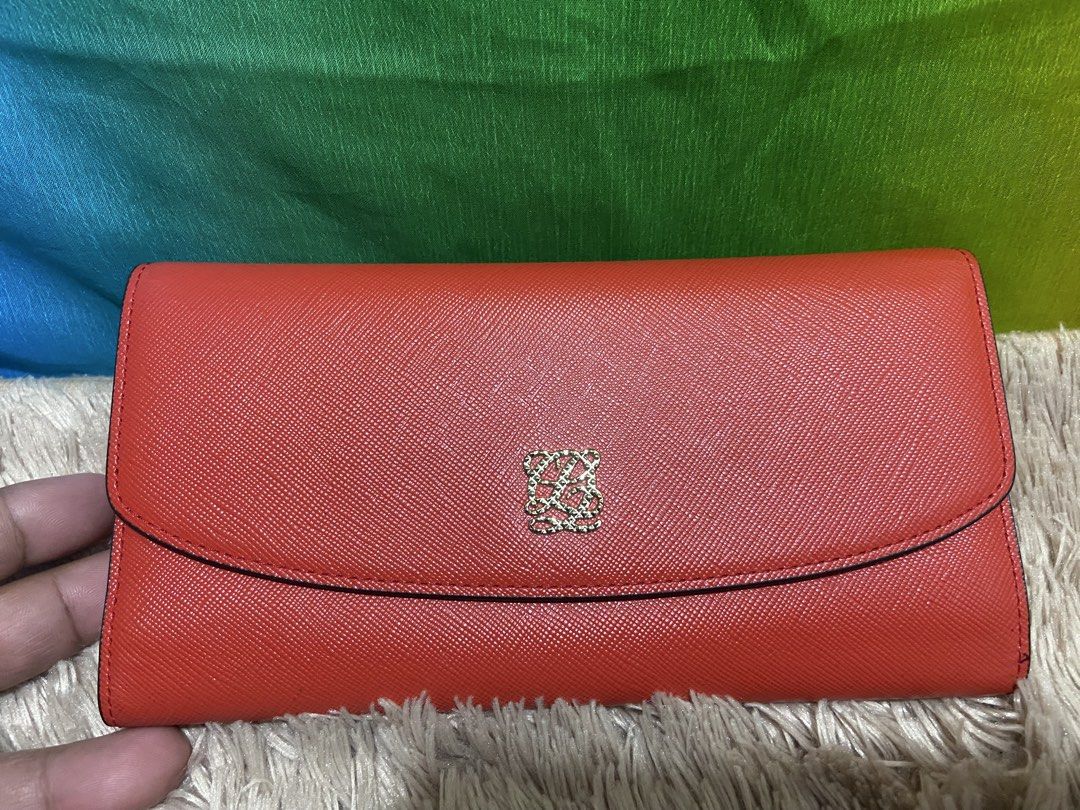 Louis Quatorze Red Leather Long Wallet (Category: Wallets & Card holders) located in Pasig City. Submitted by jie_russ (Listing ID 1461425432, Image 1). Description: - Authentic Louis Quatorze red leather long wallet - Elegant gold emblem on the front - Beige interior with stylish red accents - Ample card slots and compartments for organization - Secure and convenient snap closure.