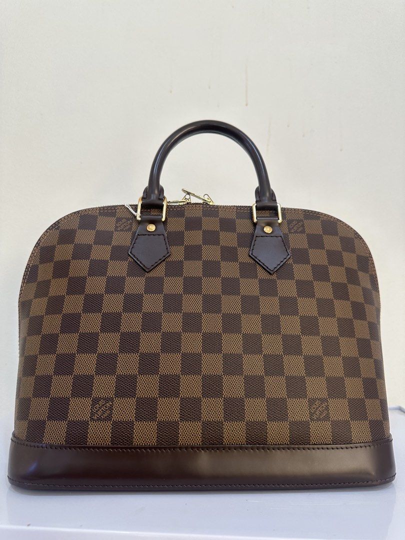 Louis Vuitton Damier Ebene Alma BB (Category: Luxury Bags & Wallets) located in Malabon City. Submitted by everythingpreloveddd (Listing ID 1461375287, Image 3). Description: - Classic Louis Vuitton Alma BB Bag - Authentic Damier Ebene Monogram Canvas - Structured Design with Leather Trim & Handles - Elegant Gold-Tone Hardware - Secure Zipper Closure - Ideal for Everyday Use - Spacious Interior for Essentials.