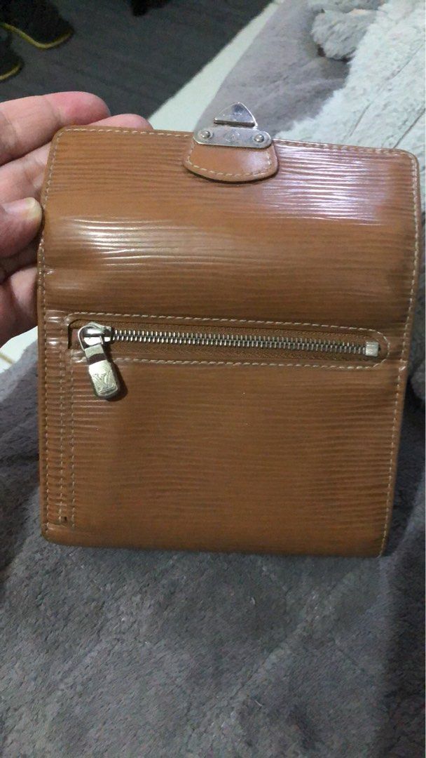 Louis Vuitton Epi Leather Wallet (Category: Luxury Bags & Wallets) located in Angeles City. Submitted by vilma43 (Listing ID 1461507542, Image 3). Description: - Authentic Louis Vuitton wallet - Rich brown Epi leather - Secure snap closure - Convenient zippered coin pocket - Multiple interior card slots - Shows some signs of wear, adding character - Fully functional and a timeless accessory.