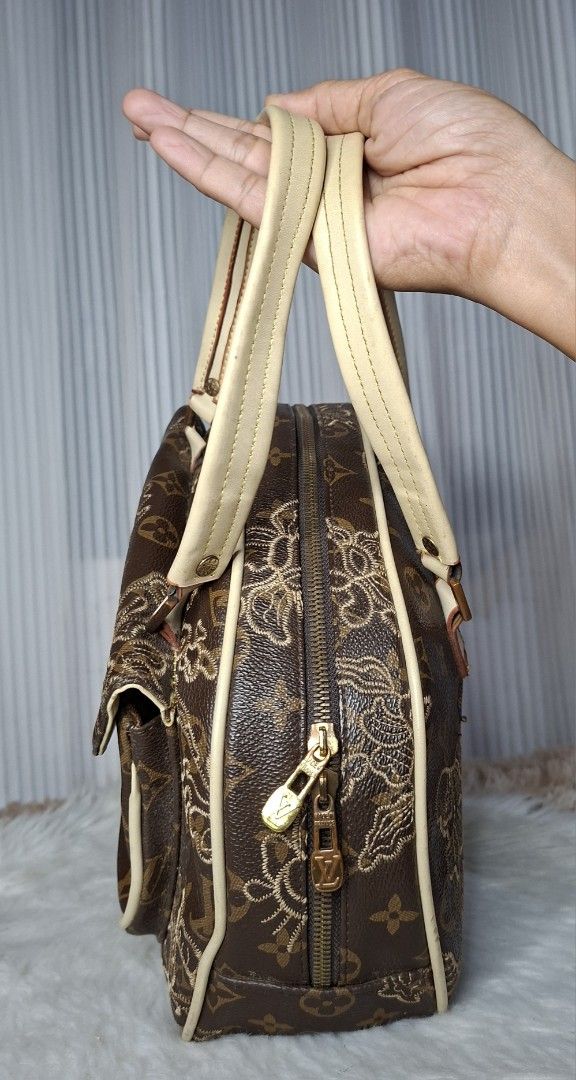 Louis Vuitton Monogram Embroidered Handbag (Category: Luxury Bags & Wallets) located in Nabua. Submitted by alasaasche36553 (Listing ID 1461433287, Image 3). Description: - Rare Brown Louis Vuitton Monogram Handbag - Features intricate floral embroidery on front flap and sides - Beige leather handles and trim - Gold-tone hardware with front clasp closure - Zipper closure along the top - A stylish and unique statement piece.