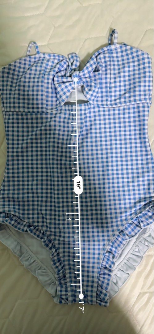 Lovito Blue Gingham One-Piece Swimsuit with Ruffles (Category: Bikinis & Swimsuits) located in Manila. Submitted by mmilaomls (Listing ID 1461434658, Image 2). Description: - Adorable blue gingham one-piece swimsuit - Features a cute tie-front detail - Ruffled leg openings for extra flair - Ideal for beach or pool outings - Measurements: Length 19", Waist 14", Bust 12" - Never used. Never worn. Wala na nga lang tag and stickers. - Kunin nyo na pl