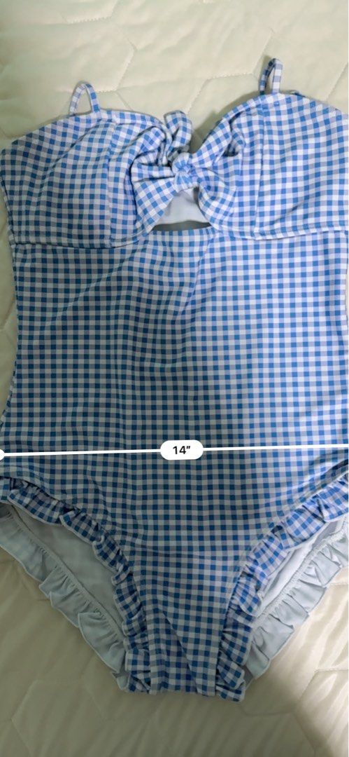Lovito Blue Gingham One-Piece Swimsuit with Ruffles (Category: Bikinis & Swimsuits) located in Manila. Submitted by mmilaomls (Listing ID 1461434658, Image 3). Description: - Adorable blue gingham one-piece swimsuit - Features a cute tie-front detail - Ruffled leg openings for extra flair - Ideal for beach or pool outings - Measurements: Length 19", Waist 14", Bust 12" - Never used. Never worn. Wala na nga lang tag and stickers. - Kunin nyo na pl