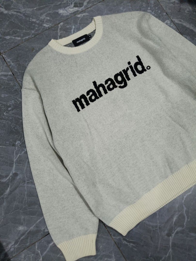 Mahagrid Basic Logo Knit Sweater Grey (Category: Coats, Jackets and Outerwear) located in Valenzuela. Submitted by 2ndhandmarket.ph (Listing ID 1461465853, Image 2). Description: - Mahagrid knit sweater in classic grey - Features iconic black Mahagrid logo - Ribbed cuffs, collar, and hem for a snug fit - Stylish cream-colored trim on hem and cuffs - Crafted from a comfortable polyester blend - Ideal for everyday casual wear Width: 23.5 Length: 26