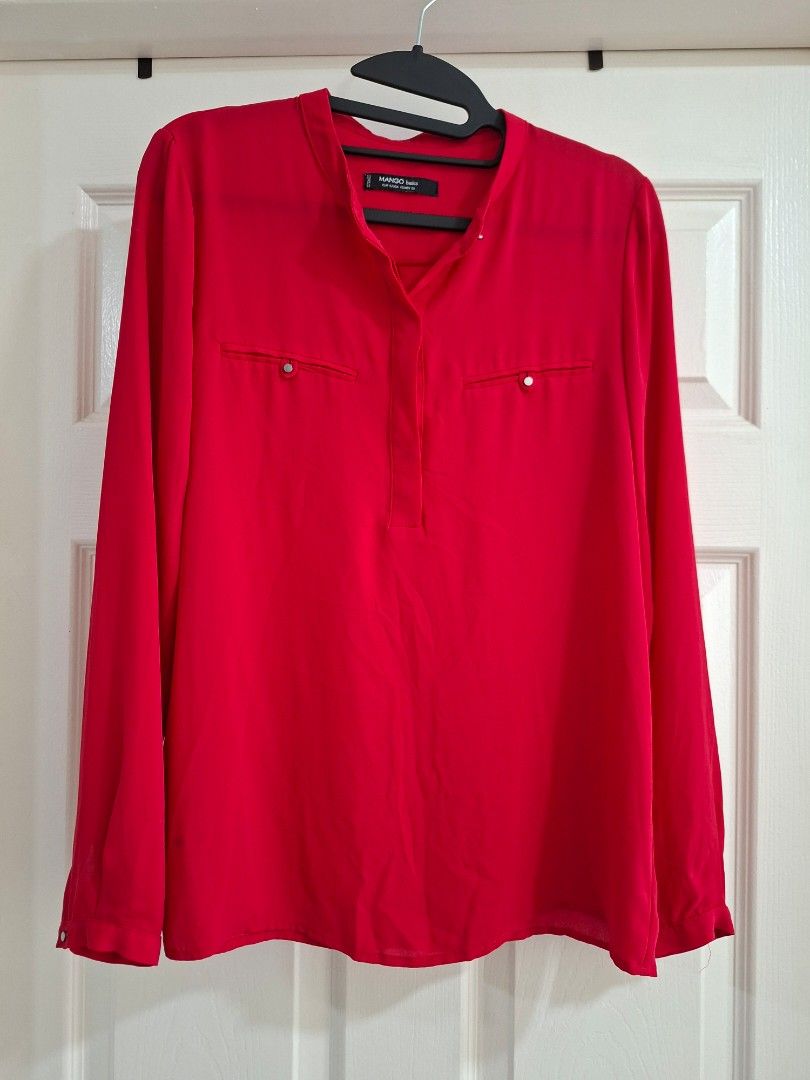Mango Basics Red Long Sleeve Blouse (Category: Blouses) located in Pasig City. Submitted by avcan (Listing ID 1461393791, Image 1). Description: - Mango Basics red long sleeve blouse - Two chest pockets with button details - Button closure at neckline - Button details on sleeve cuffs - Made in Vietnam - Versatile for casual or work wear.