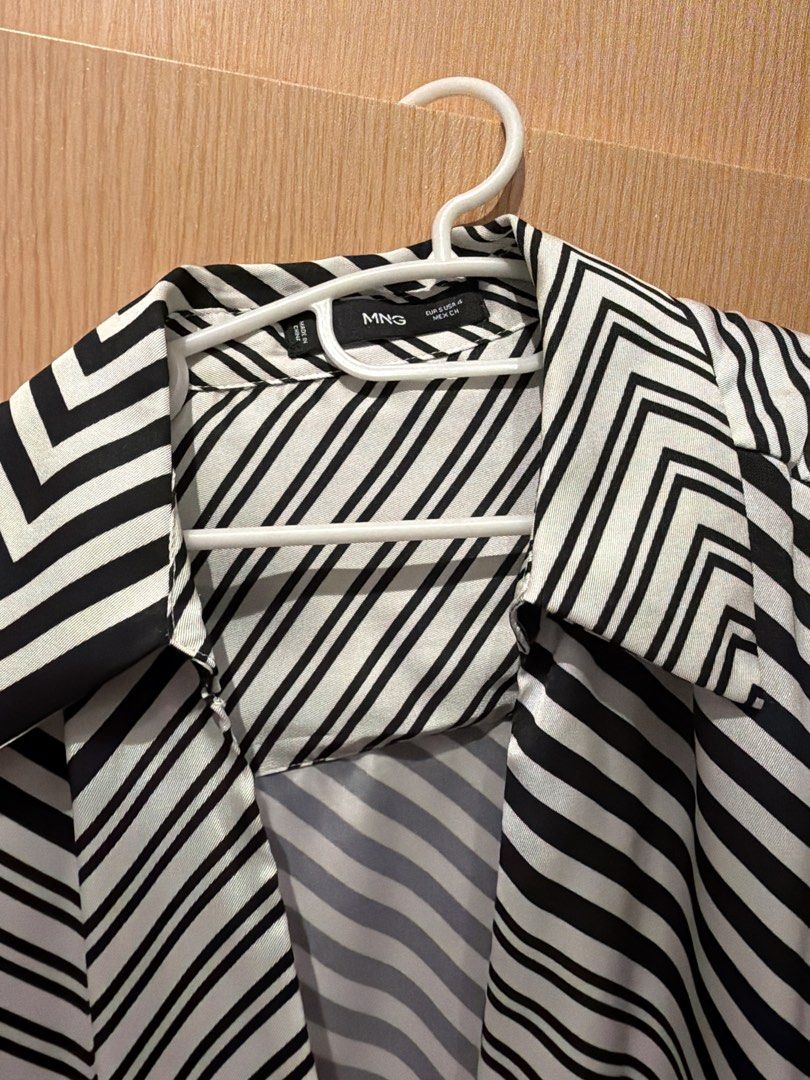 Mango Black & White Striped Wrap Dress (Category: Dresses) located in Taguig. Submitted by gabgabie (Listing ID 1461488364, Image 3). Description: - Bold black and white stripe pattern - Flattering wrap dress style - Long sleeves with button cuffs - Adjustable tie waist for a perfect fit - Fabric has a beautiful sheen - Versatile: dress up or down - Chic and stylish look.