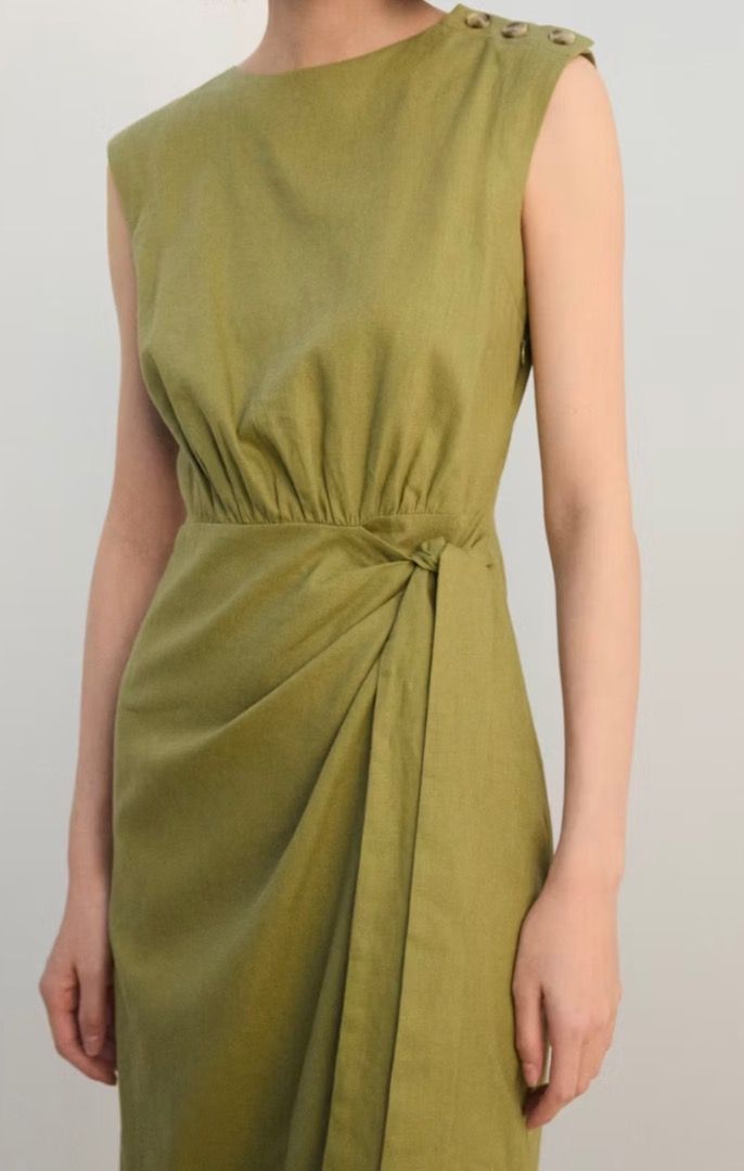 Mango Linen Wrap Dress - Olive Green (Category: Dresses) located in Mandaluyong City. Submitted by unworntobarelyworn (Listing ID 1461334595, Image 2). Description: - Brand new Mango linen wrap dress - Color: Olive Green - Style: Sleeveless, midi length - Features: Tie waist, button details on shoulder - Condition: Never worn - Versatile: Perfect for dressing up or office attire - Can fit XS to S - Original price P3,295.