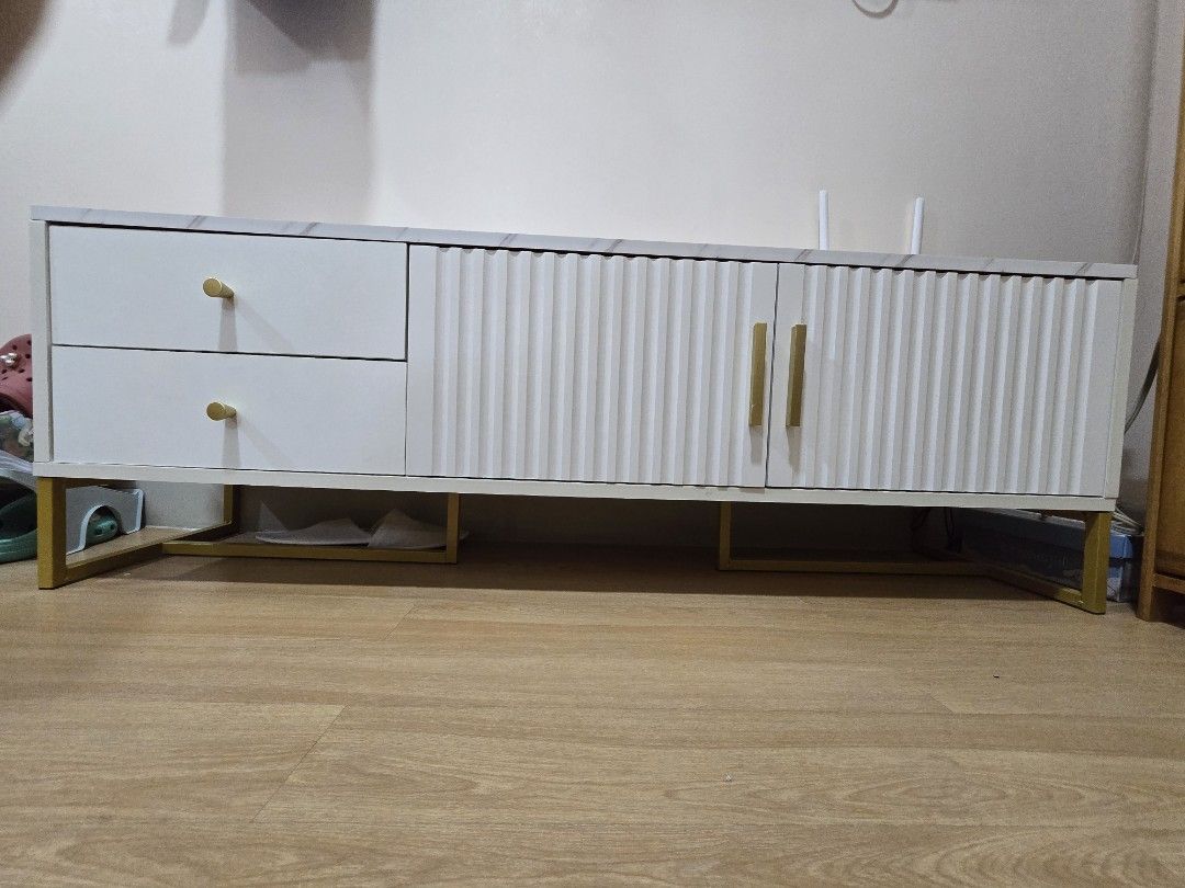 Marble White + Gold Classic Minimalist TV Rack (Category: TV Consoles) located in Quezon City. Submitted by lorenandi (Listing ID 1461348621, Image 1). Description: * 120 x 30 x 40cm * Already built * Used for 1 month only. Selling because will upgrade to a bigger one.