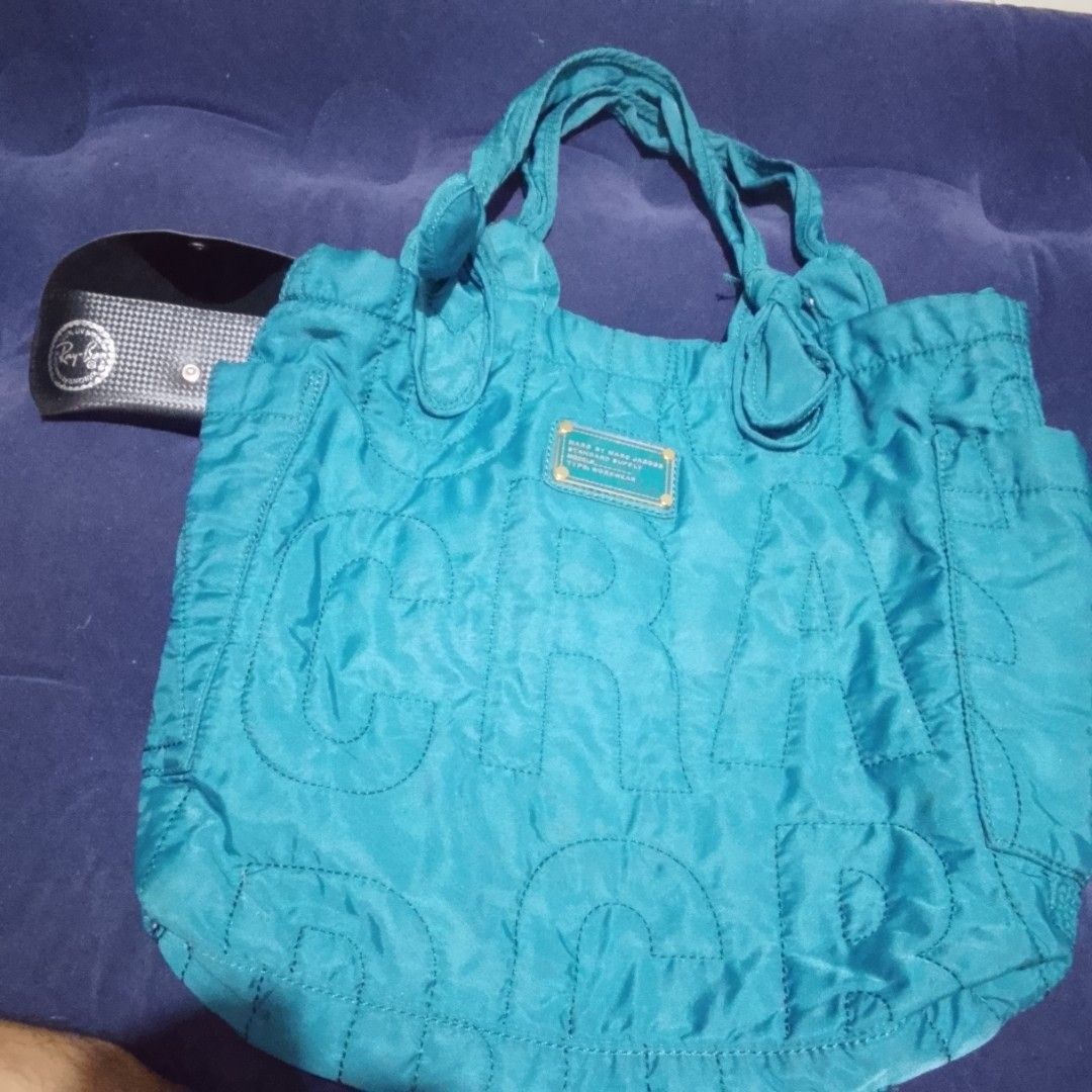 Marc by Marc Jacobs Standard Supply Tote Bag (Category: Luxury Bags & Wallets) located in Manila. Submitted by johnaben2021 (Listing ID 1461359776, Image 3). Description: - Marc by Marc Jacobs tote bag - Teal color with all-over logo print - Front zipper pocket - Two top handles - Interior tag: 'Standard Supply', 'Type: Workwear' - Ideal for everyday use.