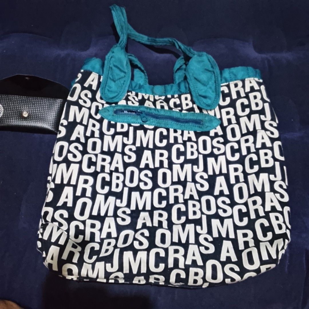 Marc by Marc Jacobs Standard Supply Tote Bag (Category: Luxury Bags & Wallets) located in Manila. Submitted by johnaben2021 (Listing ID 1461359776, Image 1). Description: - Marc by Marc Jacobs tote bag - Teal color with all-over logo print - Front zipper pocket - Two top handles - Interior tag: 'Standard Supply', 'Type: Workwear' - Ideal for everyday use.