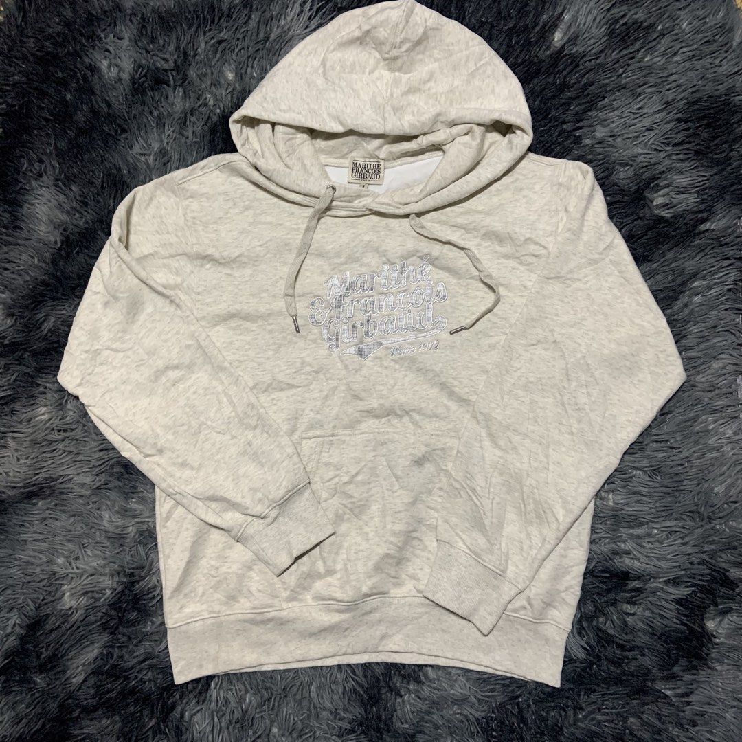 Marithe Francois Girbaud Paris 1972 Hoodie Size S (Category: Coats, Jackets and Outerwear) located in Compostela. Submitted by anyastark (Listing ID 1461382152, Image 1). Description: - Marithe Francois Girbaud hoodie - Color: Light grey marl - Size: Tagged S - Features: Embroidered brand name and 'Paris 1972' on front, drawstring hood with metal tips, kangaroo pocket - Material: Cotton blend - Dirt Stain Washable - Width 22 - Length 26.