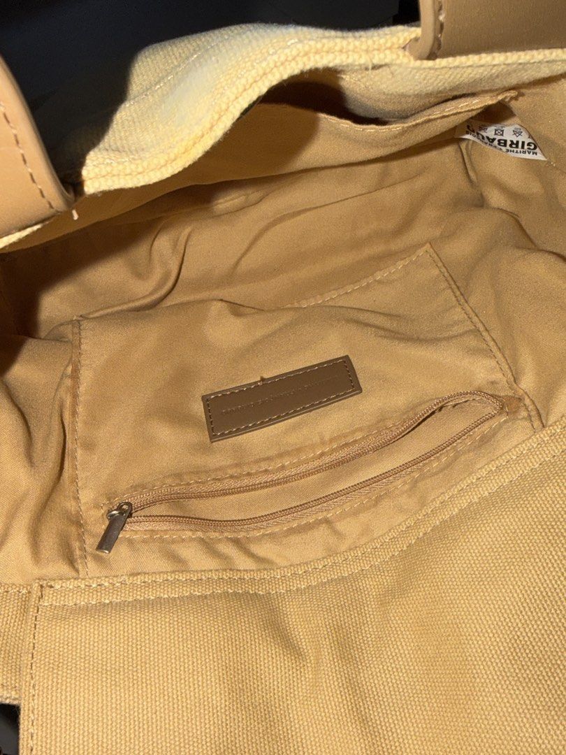 Marithe Girbaud Canvas Handbag (Category: Luxury Bags & Wallets) located in Manila. Submitted by hatdognablue (Listing ID 1461360888, Image 3). Description: - Marithe Girbaud canvas handbag - Tan color with brown leather accents - Top handles and adjustable crossbody strap - Front zip pocket for quick access - Spacious main compartment - Interior zip pocket for essentials - Ideal for everyday use.