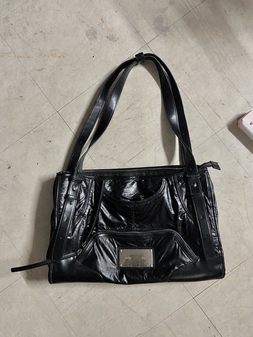 Matin Kim Black Leather Shoulder Bag (Category: Shoulder Bags) located in Manila. Submitted by reirapture (Listing ID 1461442582, Image 3). Description: - Brand: Matin Kim - Material: Black Leather - Finish: Shiny, slightly crinkled - Features: Multiple zippered pockets, front pouch - Straps: Adjustable with buckle details - Hardware: Silver-tone logo plate - Interior: Spacious, ideal for everyday use NEGOTIABLE PA!!!.